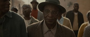 Movie still from “Selma” (2014), directed by Ava DuVernay – An older man wearing a hat and glasses; Close Up shot, Over the shoulder angle