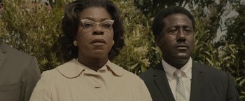 Movie still from “Selma” (2014), directed by Ava DuVernay – A man and a woman standing next to each other in front of trees; Close Up shot, Low angle
