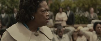 Movie still from “Selma” (2014), directed by Ava DuVernay – An older black woman in a white coat; Close Up shot, Over the shoulder angle