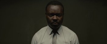 Movie still from “Selma” (2014), directed by Ava DuVernay – A man wearing a white shirt and a gray tie; Close Up shot, Low angle