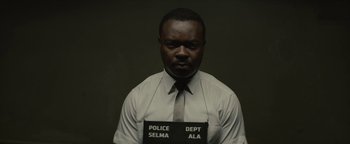 Movie still from “Selma” (2014), directed by Ava DuVernay – A man in a tie and a police badge; Close Up shot, Low angle