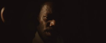 Movie still from “Selma” (2014), directed by Ava DuVernay – A man's face in the dark; Extreme Close Up shot, High angle