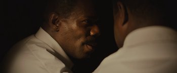 Movie still from “Selma” (2014), directed by Ava DuVernay – A man's face in a dark room; Close Up shot, Over the shoulder angle