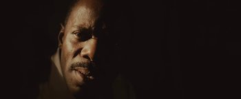 Movie still from “Selma” (2014), directed by Ava DuVernay – A person's face in the dark; Extreme Close Up shot, Low angle