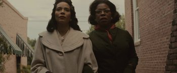 Movie still from “Selma” (2014), directed by Ava DuVernay – Two women standing next to each other in front of a building; Medium shot, Low angle