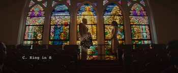 Movie still from “Selma” (2014), directed by Ava DuVernay – A man and a woman standing in front of a stained glass window; Wide shot, Low angle