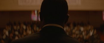 Movie still from “Selma” (2014), directed by Ava DuVernay – A person's face in a suit; Close Up shot, Low angle