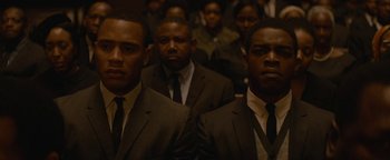 Movie still from “Selma” (2014), directed by Ava DuVernay – A group of men in suits and ties in front of a crowd; Close Up shot, High angle