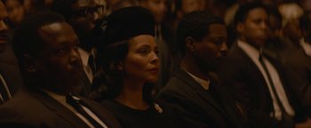 Movie still from “Selma” (2014), directed by Ava DuVernay – A woman wearing a black hat and a man wearing a black suit; Close Up shot, High angle