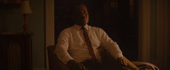 Movie still from “Selma” (2014), directed by Ava DuVernay – A man sitting in a chair wearing a white shirt and a tie; Close Up shot, Over the shoulder angle
