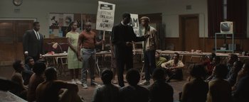 Movie still from “Selma” (2014), directed by Ava DuVernay – A group of people standing in front of a group of protesters; Wide shot, High angle