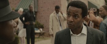Movie still from “Selma” (2014), directed by Ava DuVernay – A man standing in front of a brick building; Close Up shot, Over the shoulder angle