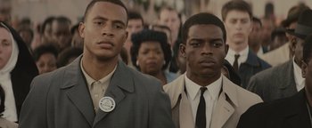 Movie still from “Selma” (2014), directed by Ava DuVernay – A group of men standing next to each other in front of a crowd of onlookers; Close Up shot, Over the shoulder angle
