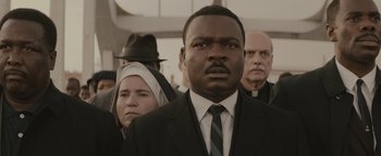 Movie still from “Selma” (2014), directed by Ava DuVernay – A group of people in suits and ties; Close Up shot, Over the shoulder angle
