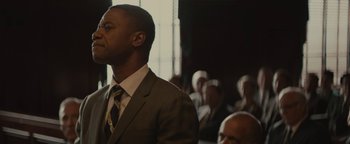 Movie still from “Selma” (2014), directed by Ava DuVernay – A man in a suit and a tie; Close Up shot, Low angle