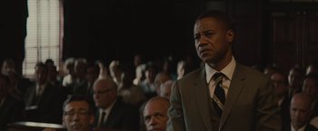 Movie still from “Selma” (2014), directed by Ava DuVernay – A man in a suit standing in front of an audience; Close Up shot, Over the shoulder angle