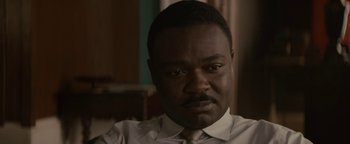 Movie still from “Selma” (2014), directed by Ava DuVernay – A person wearing a shirt and tie; Close Up shot, Over the shoulder angle
