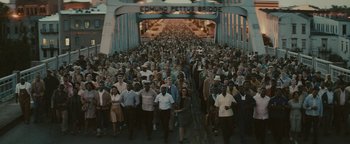 Movie still from “Selma” (2014), directed by Ava DuVernay – A large group of people walking across a bridge; Extreme Wide shot, High angle