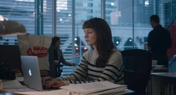 Movie still from “She Said” (2022), directed by Maria Schrader – A woman sitting in front of a computer at a desk; Medium shot, High angle