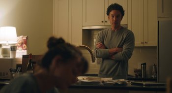 Movie still from “She Said” (2022), directed by Maria Schrader – A man standing in a kitchen next to a woman; Medium shot, Over the shoulder angle