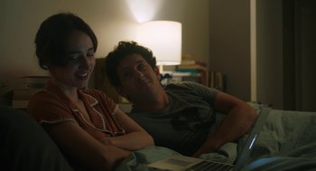 Movie still from “She Said” (2022), directed by Maria Schrader – A man and a woman sitting in front of an open laptop computer; Medium shot, Over the shoulder angle