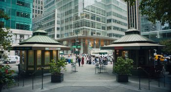 Movie still from “She Said” (2022), directed by Maria Schrader – People are walking on the sidewalk in a city; Extreme Wide shot, High angle
