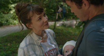 Movie still from “She Said” (2022), directed by Maria Schrader – A woman holding a baby and talking to a man; Close Up shot, Over the shoulder angle