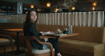 Movie still from “She Said” (2022), directed by Maria Schrader – A woman sitting at a table in front of a bowl of soup; Medium shot, High angle