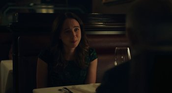 Movie still from “She Said” (2022), directed by Maria Schrader – A woman sitting at a table with a glass of wine in front of her; Close Up shot, Over the shoulder angle
