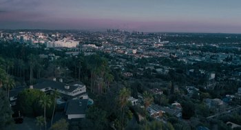 Movie still from “She Said” (2022), directed by Maria Schrader – An aerial view of a city at dusk; Extreme Wide shot, High angle