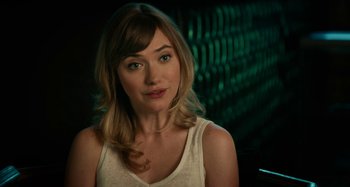 Movie still from “She's Funny That Way” (2014), directed by Peter Bogdanovich – A beautiful woman with long blonde hair wearing a white shirt; Close Up shot, Over the shoulder angle