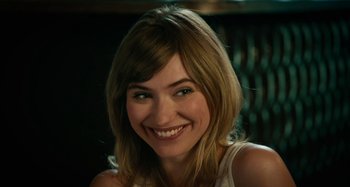 Movie still from “She's Funny That Way” (2014), directed by Peter Bogdanovich – A person smiling for the camera; Close Up shot, Over the shoulder angle