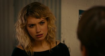 Movie still from “She's Funny That Way” (2014), directed by Peter Bogdanovich – A beautiful young woman with long blonde hair and green eyes; Close Up shot, Over the shoulder angle