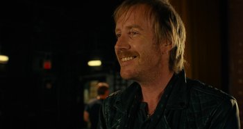 Movie still from “She's Funny That Way” (2014), directed by Peter Bogdanovich – A person with long hair; Close Up shot, Over the shoulder angle