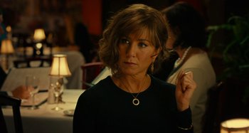 Movie still from “She's Funny That Way” (2014), directed by Peter Bogdanovich – A person wearing a black shirt; Close Up shot, Over the shoulder angle