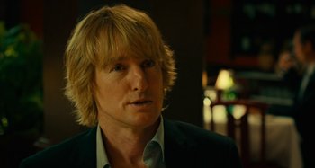 Movie still from “She's Funny That Way” (2014), directed by Peter Bogdanovich – A person wearing a suit and tie; Close Up shot, Over the shoulder angle
