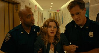 Movie still from “She's Funny That Way” (2014), directed by Peter Bogdanovich – A group of people standing next to each other in a hallway; Medium shot, Low angle