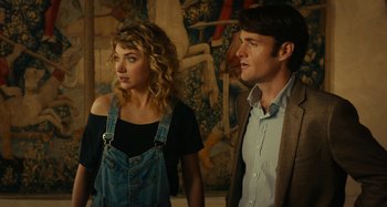 Movie still from “She's Funny That Way” (2014), directed by Peter Bogdanovich – A man and a woman standing next to each other; Medium shot, Low angle