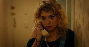 Movie still from “She's Funny That Way” (2014), directed by Peter Bogdanovich – A woman holding a phone up to her ear; Close Up shot, High angle