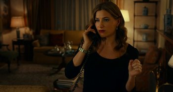 Movie still from “She's Funny That Way” (2014), directed by Peter Bogdanovich – A woman talking on a phone while standing in a living room; Close Up shot, Over the shoulder angle