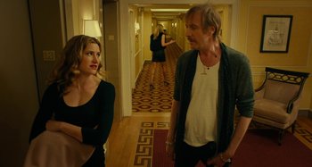 Movie still from “She's Funny That Way” (2014), directed by Peter Bogdanovich – A man and a woman standing in a hotel hallway; Medium shot, Over the shoulder angle