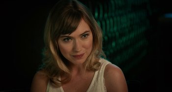 Movie still from “She's Funny That Way” (2014), directed by Peter Bogdanovich – A beautiful woman with blonde hair wearing a white shirt; Close Up shot, Over the shoulder angle