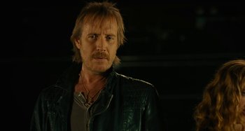 Movie still from “She's Funny That Way” (2014), directed by Peter Bogdanovich – A person wearing a leather jacket; Close Up shot, Over the shoulder angle
