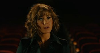 Movie still from “She's Funny That Way” (2014), directed by Peter Bogdanovich – A person wearing a jacket; Close Up shot, Over the shoulder angle