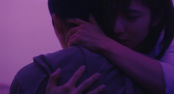 Movie still from “Shoplifters” (2018), directed by Kore-eda Hirokazu – A man and a woman embracing in a purple light; Extreme Close Up shot, Low angle