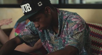 Movie still from “Short Term 12” (2013), directed by Destin Daniel Cretton – A young man wearing a hawaiian shirt and a hat; Close Up shot, High angle