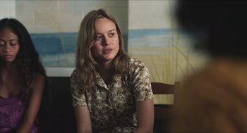 Movie still from “Short Term 12” (2013), directed by Destin Daniel Cretton – A woman sitting on a chair in front of a painting; Medium shot, Over the shoulder angle