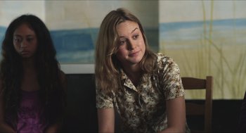 Movie still from “Short Term 12” (2013), directed by Destin Daniel Cretton – A woman sitting in front of a painting on the wall; Close Up shot, Over the shoulder angle