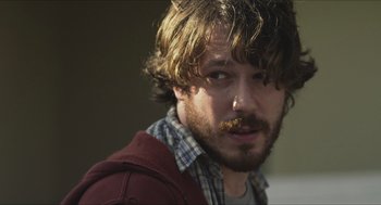 Movie still from “Short Term 12” (2013), directed by Destin Daniel Cretton – A person with a beard and mustache; Close Up shot, Over the shoulder angle