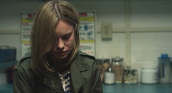 Movie still from “Short Term 12” (2013), directed by Destin Daniel Cretton – A woman in a green jacket is looking down; Close Up shot, Over the shoulder angle